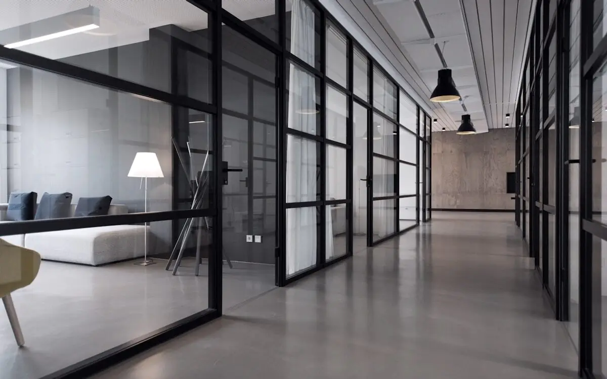 Office corridor lined with glass-panelled rooms