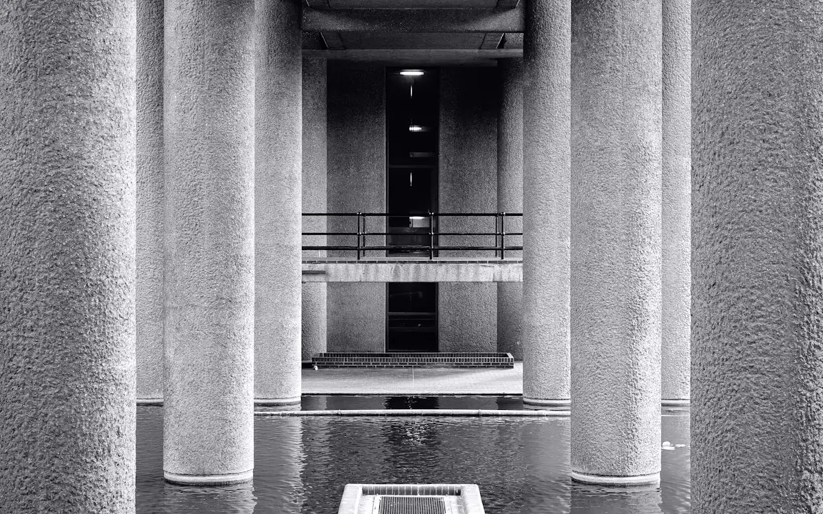 Concrete colonnade reflected in still water